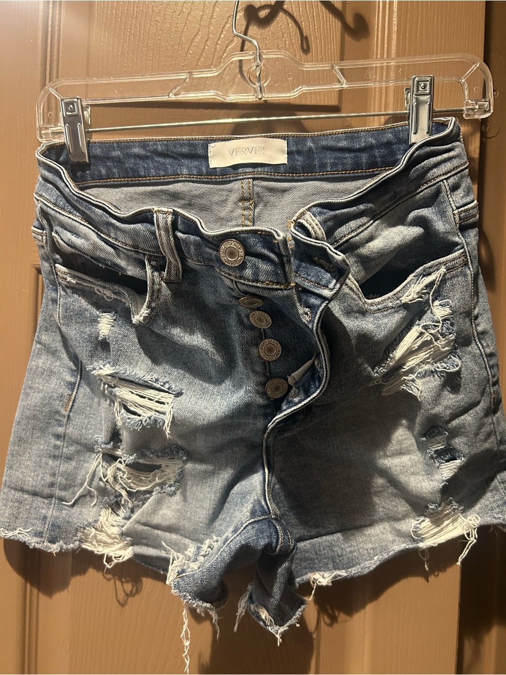 High-Rise Distressed Denim Shorts in Light Blue